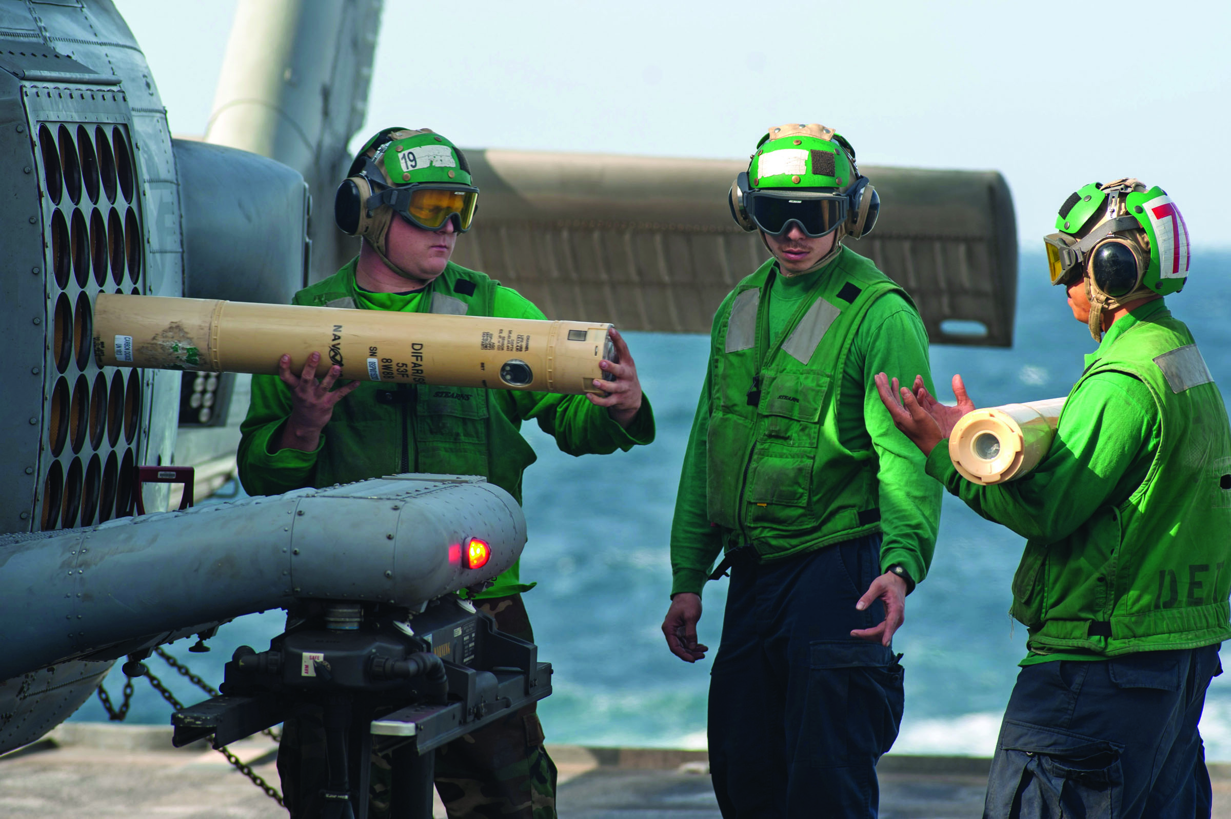 Sailors unload sonobuoys from an MH-60R Sea Hawk helicopter aboard the guided-missile cruiser USS Mobile Bay in the Arabian Sea in 2012. U.S. Navy via Associated Press