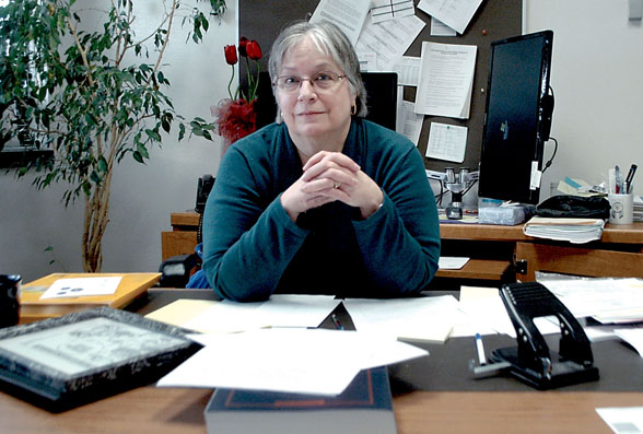 Deb Kelly pauses at her Clallam County prosecuting attorney's desk on her final actual day at work Wednesday.  —Photo by Paul Gottlieb/Peninsula Daily News