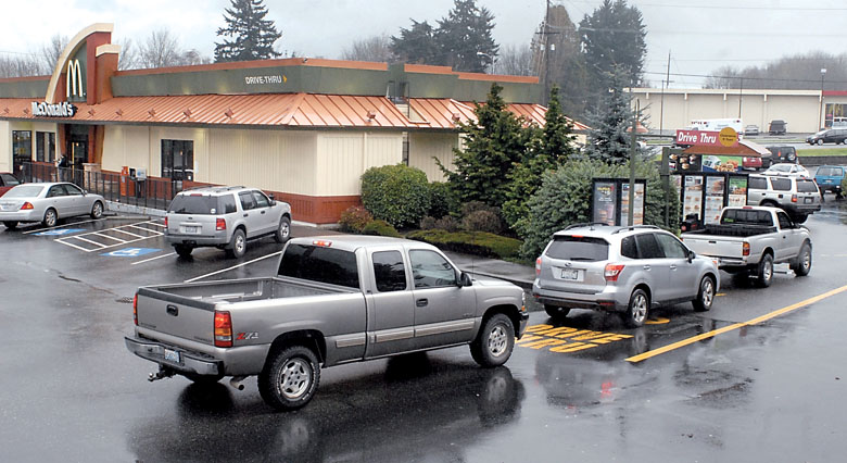 Vehicles line up for the drive-through window at the Port Angeles McDonalds restaurant on Thursday. Plans call for construction of a new restaurant with two longer drive-through lanes.  Keith Thorpe/Peninsula Daily News