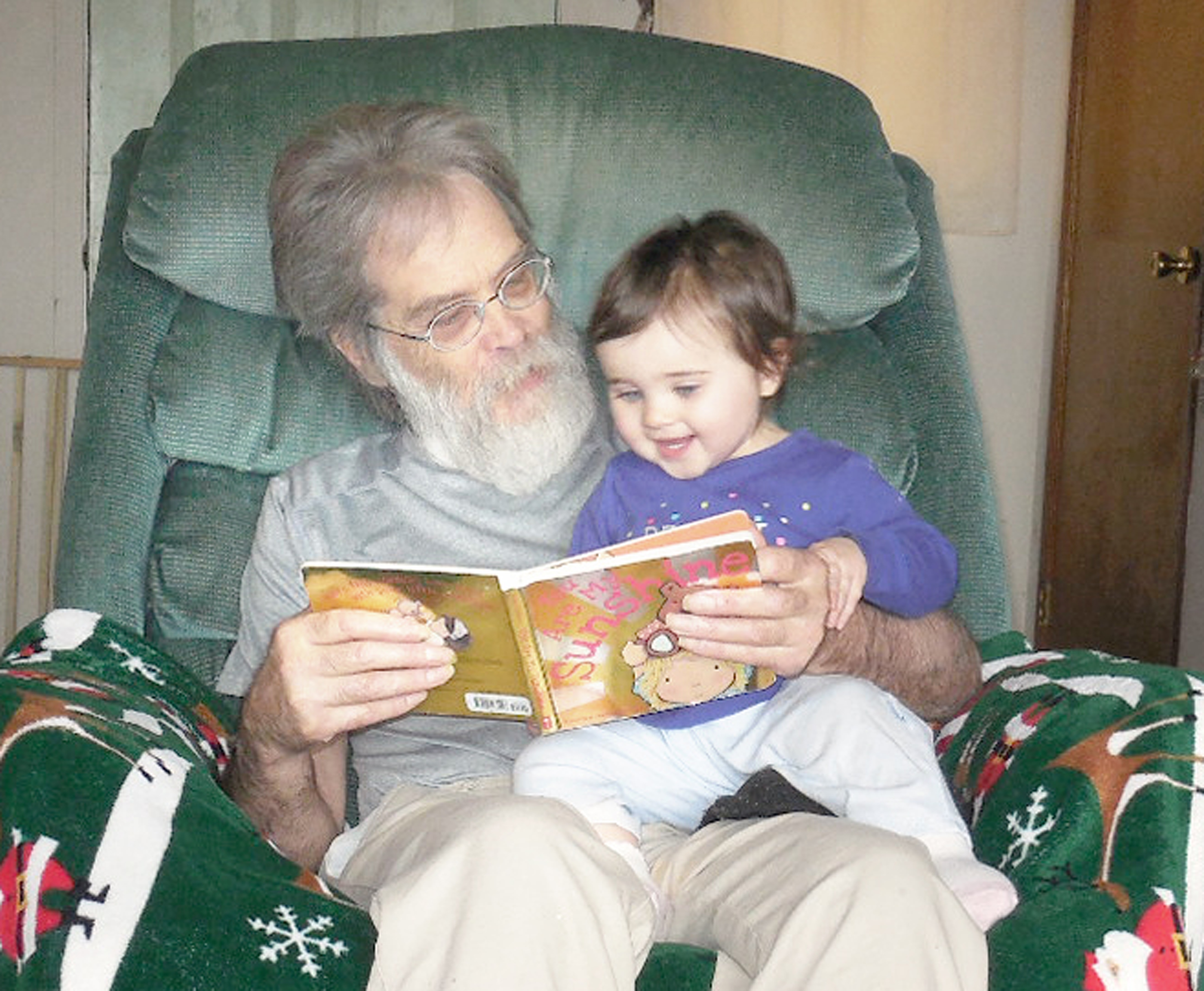 Doug Stork reads to his granddaughter