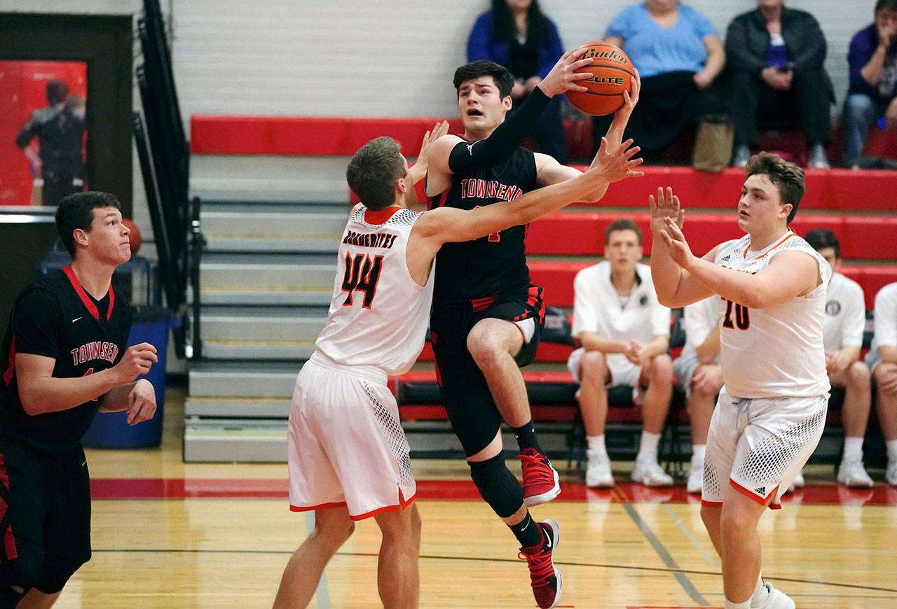 Steve Mullensky/for Peninsula Daily News Redhawk Jackson Foster watches as teammate Noa Montoya goes up for a basket against Blaine Borerites Niko Friker and Hudson Reid in a Crush in the Slush game on Friday at Port Townsend High School.