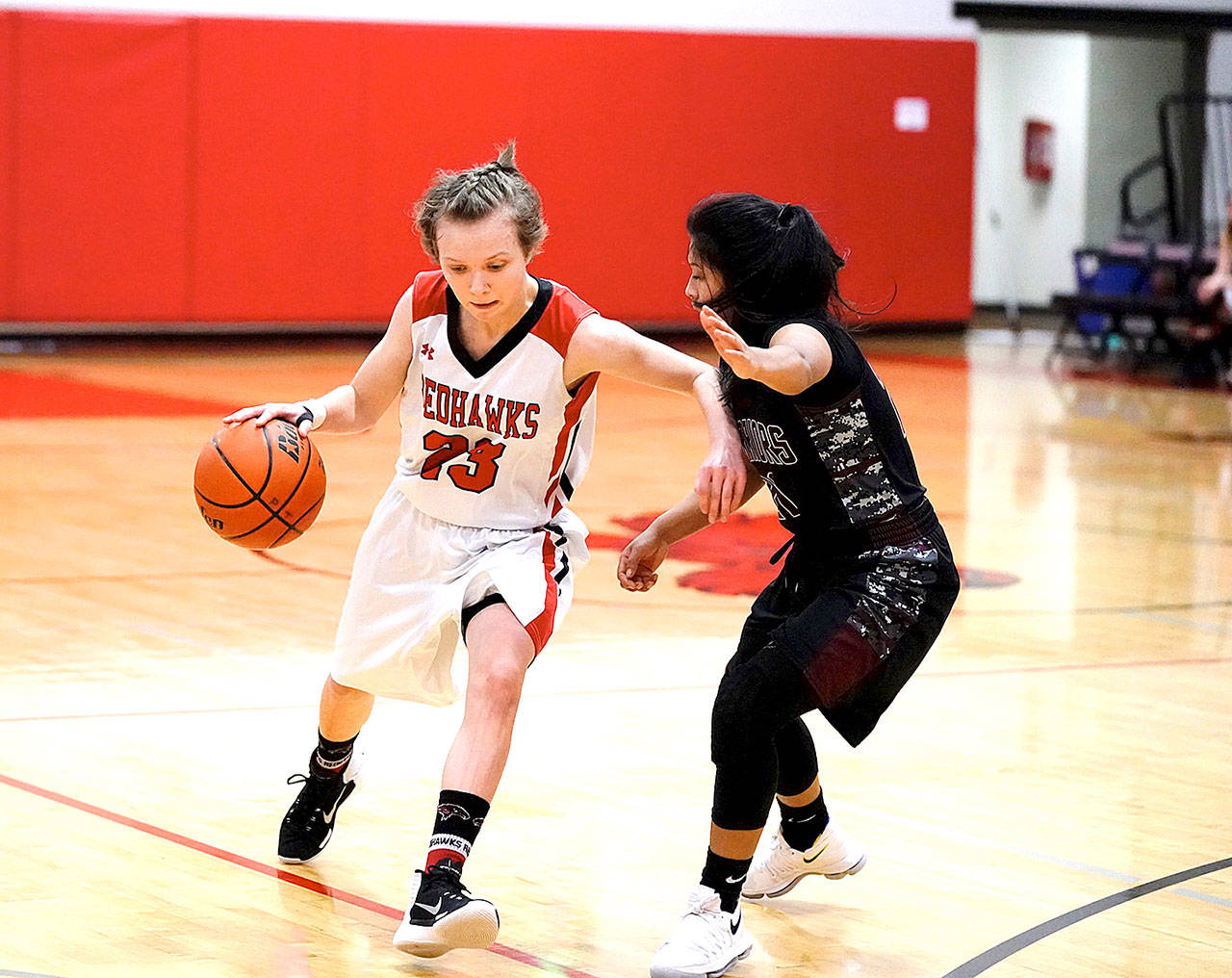 Port Townsends Mackenzie Lake pushes her way around Wahluke Warrior Jacky Hidalgo during the opening hame of the 2017 Crush in the Slush tournament at Port Townsend High School on Friday. (Steve Mullensky/for Peninsula Daily News)
