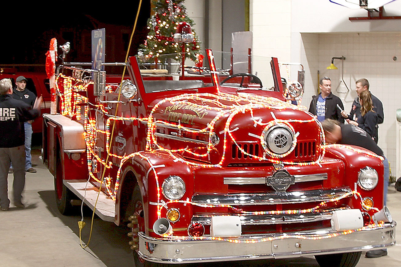 Dave Logan/for Peninsula Daily News An antique fire engine, known as Sparky, was decorated last week for the Port Angeles Fire Department’s 32th Annual Operation Candy Cane, which is in progress each evening through Thursday.