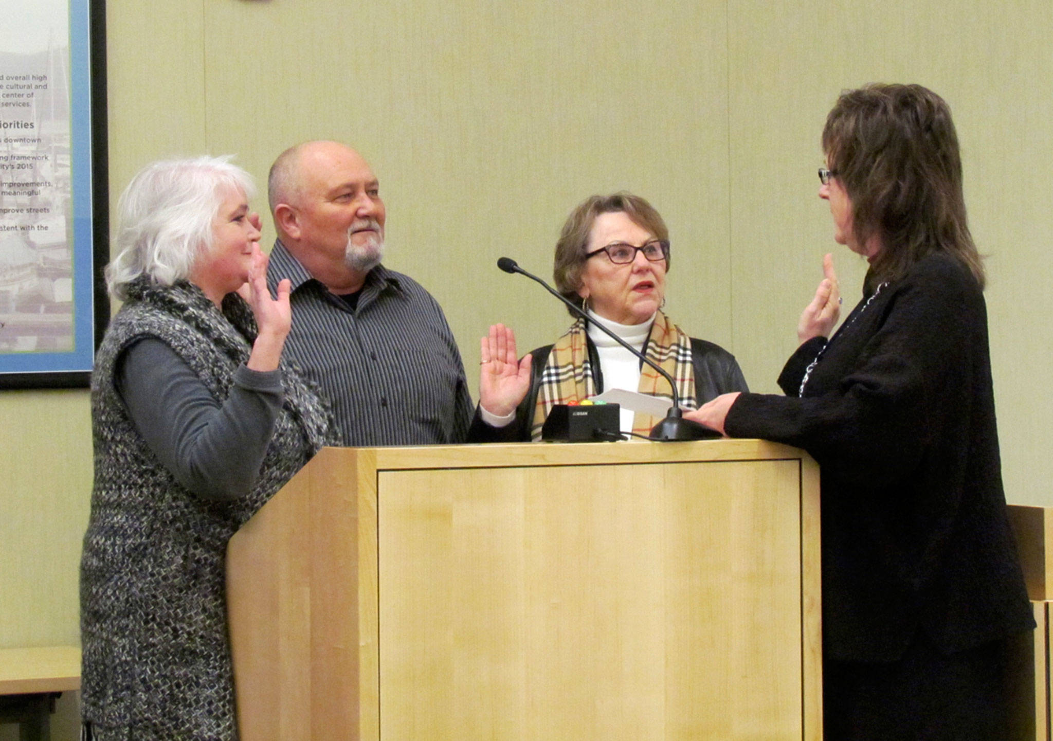 Sequim City Council members, from left, Pam Leonard- Ray, John Miller, and Candace Pratt take the oath of office in Jan. 2016 from Sequim City Clerk Karen Kuznek-Reese. Miller died Wednesday, and Leonard-Ray said “they will have a difficult time filling his shoes with someone with the same connections.” Photo courtesy City of Sequim