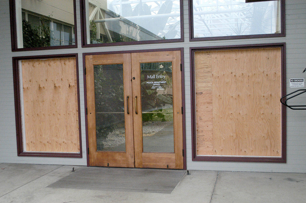The damaged north entrance to Port Angeles City Hall is shown Saturday. Police said Wesley Alcorn threw landscaping rocks into the windows. (Rob Ollikainen/Peninsula Daily News)
