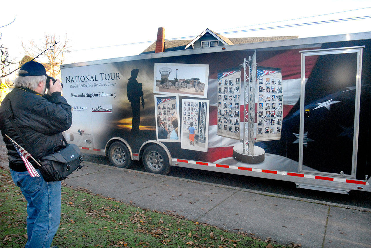 Captain Joseph House volunteer Tom Fenner of Sequim takes a photo of a trailer containing 30 “tribute towers” that will be erected this weekend as part of the “Remembering Our Fallen” tour that pays tribute to soldiers killed in action since the terrorist attacks of Sept. 11, 2001. The memorial will be on display from Friday through Monday at the Captain Joseph House, 1108 S Oak St., in Port Angeles. The truck and trailer containing the towers arrived in Port Angeles on Wednesday with a motorcycle escort by the American Legion Riders. (Keith Thorpe/Peninsula Daily News)