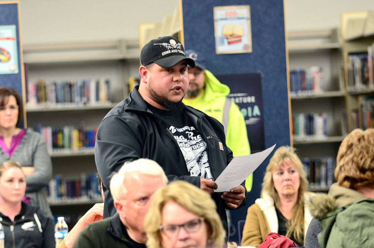 Joe Inciong, a parent of a Chimacum High School student, reads a letter from a group of parents who are frustrated with how school administrators are treating their kids during a parent forum Wednesday night at CHS. (Jesse Major/Peninsula Daily News)