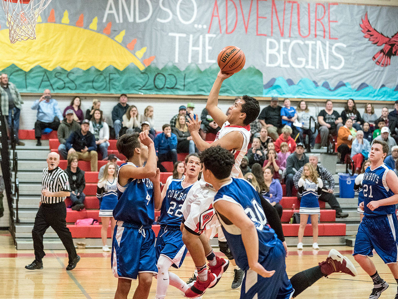 &lt;strong&gt;Steve Mullensky&lt;/strong&gt;/for Peninsula Daily News                                Port Townsend’s Jacob Boucher makes the basket while surrounded by a trio of Chimacum Cowboys during the Redhawks’ 79-36 win Friday.
