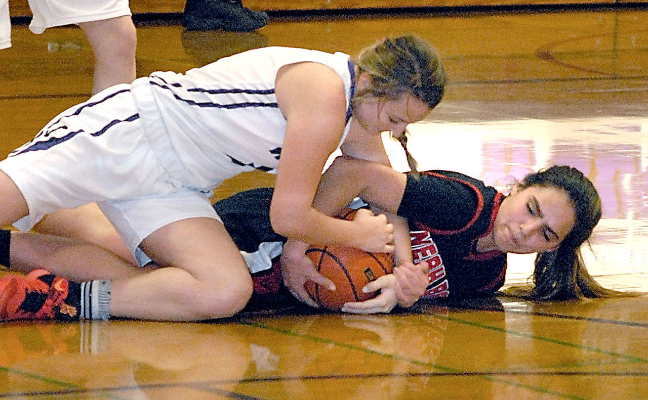 Keith Thorpe/Peninsula Daily News Sequim’s Bobbi Sparks, top, and Neah Bay’s Courtney Swan battle for a loose ball in the closing minutes of Tuesday night’s matchup at Sequim High School.