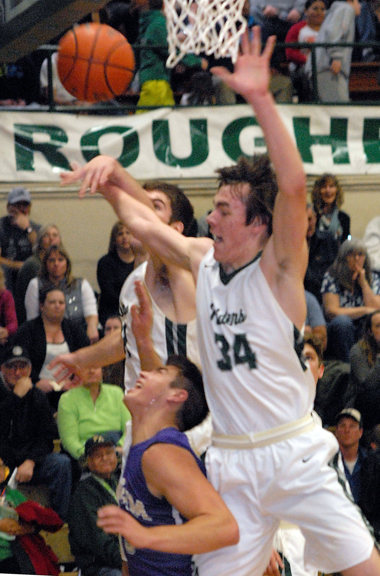 Keith Thorpe/Peninsula Daily News Sequim’s Payton Glasser, bottom, looks up in dismay as Port Angeles’ Garrett Edwards, left and Liam Clark bat away Glasser’s layup in first quarter play on Wednesday in Port Angeles.