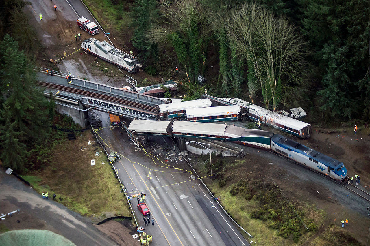 Cars from an Amtrak train that derailed lie spilled onto Interstate 5 on Monday in DuPont. (Bettina Hansen/The Seattle Times via AP)