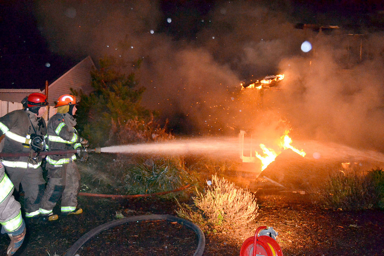 A house on 3 Crabs Rod was destroyed by fire Monday night. (Matthew Nash/Olympic Peninsula News Group)