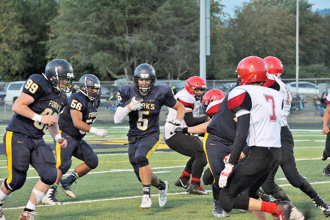 Lonnie Archibald/for Peninsula Daily News Forks’ Cole Baysinger eyes a running lane during a win over Neah Bay. Baysinger was an electrifying force for Forks and is the 2017 All-Peninsula Football MVP.