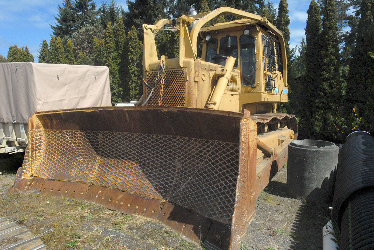 The bulldozer used by Barry Swegle is shown impounded by the Clallam County Sheriff’s Office in May 2015. (Keith Thorpe/Peninsula Daily News)