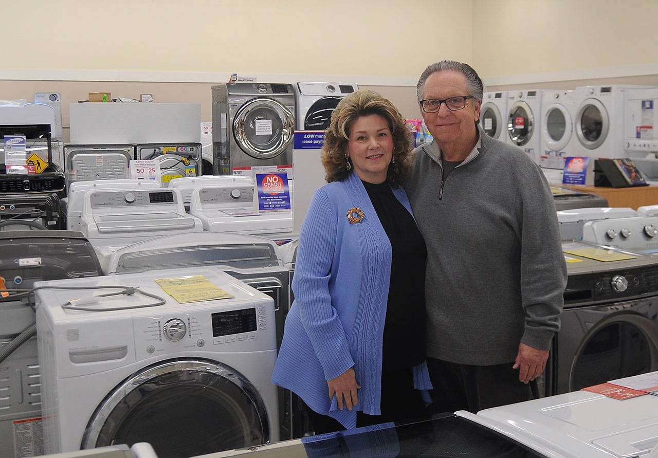 Bob Grey, pictured with wife Annemarie, is calling it a career after 50 years in retail, the past 20 as owner of Sequim Sears Hometown Store. (Michael Dashiell/Olympic Peninsula News Group)