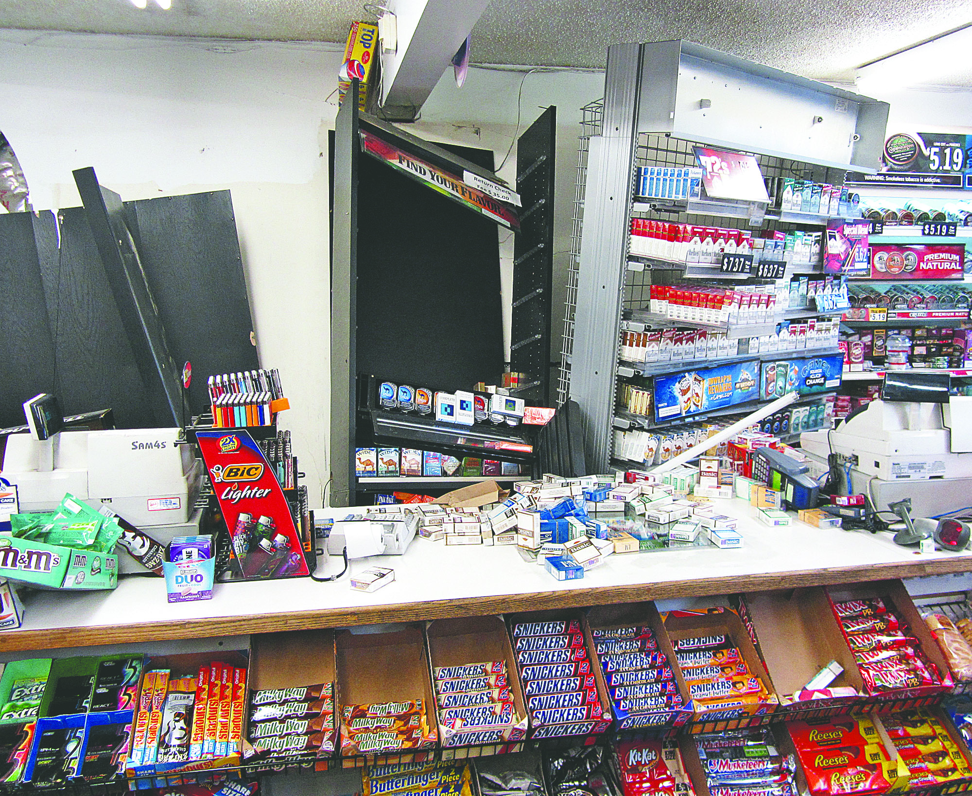 Product shelves inside the Grandview grocery are pushed askew after a car rammed the building Tuesday. Cami Cromer