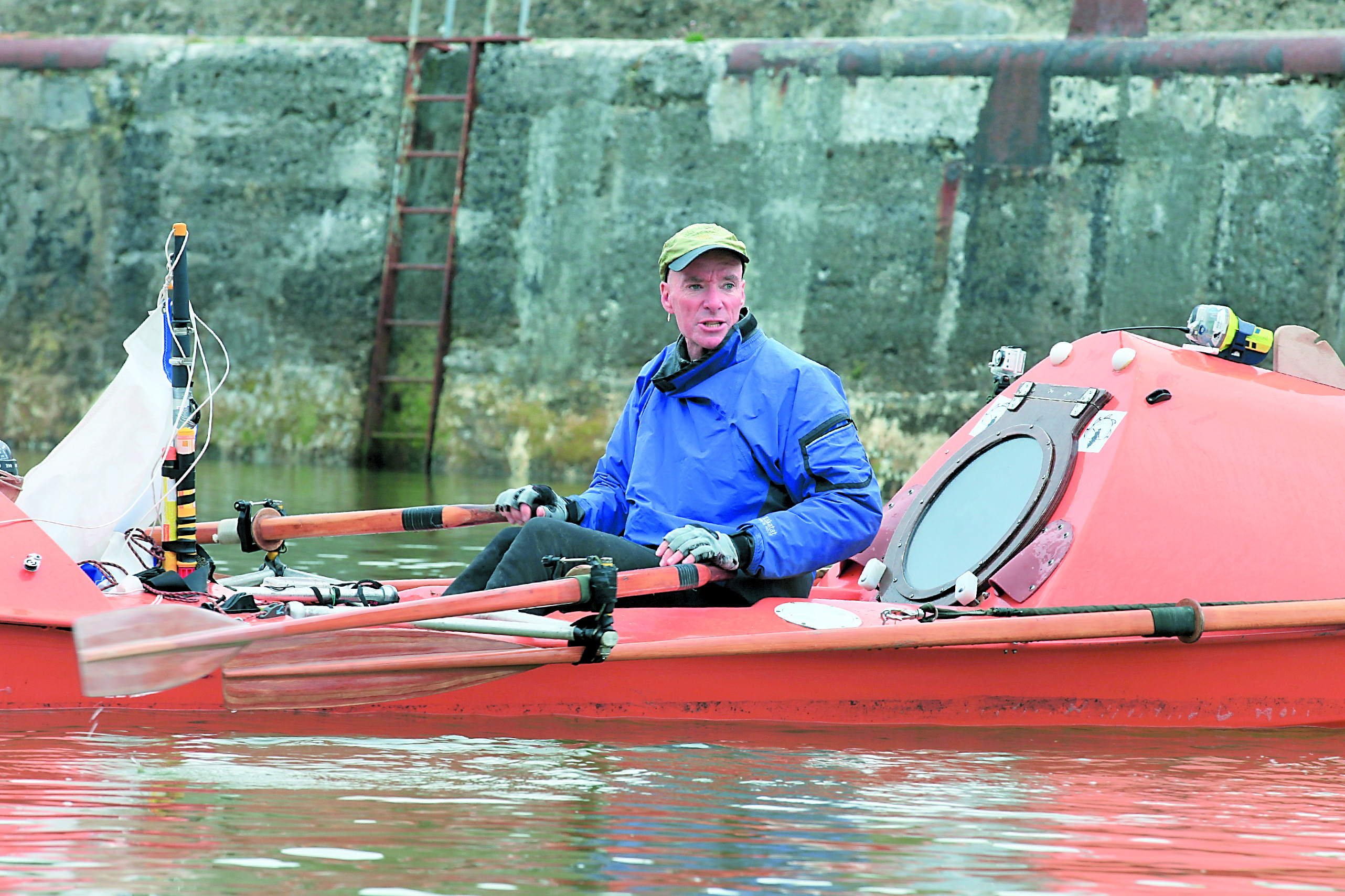 Port Angeles adventurer Chris Duff is seen preparing for his journey from Scotland to Iceland on his boat