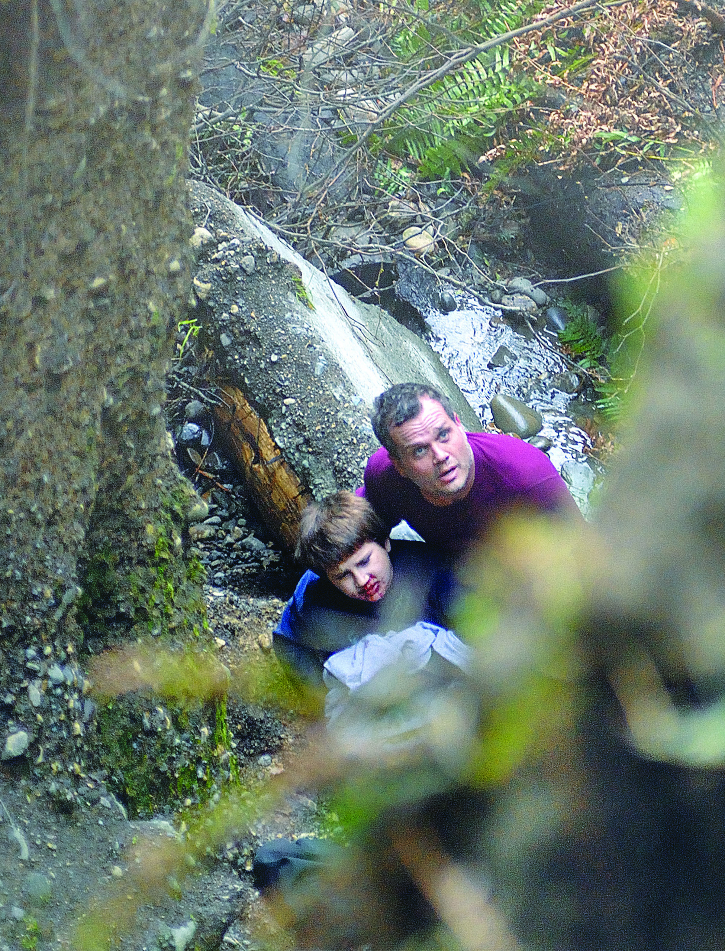 David Jangula holds a boy identified only as Justice who fell down a bluff in west Port Angeles.  -- Photo by Chris Tucker/Peninsula Daily News