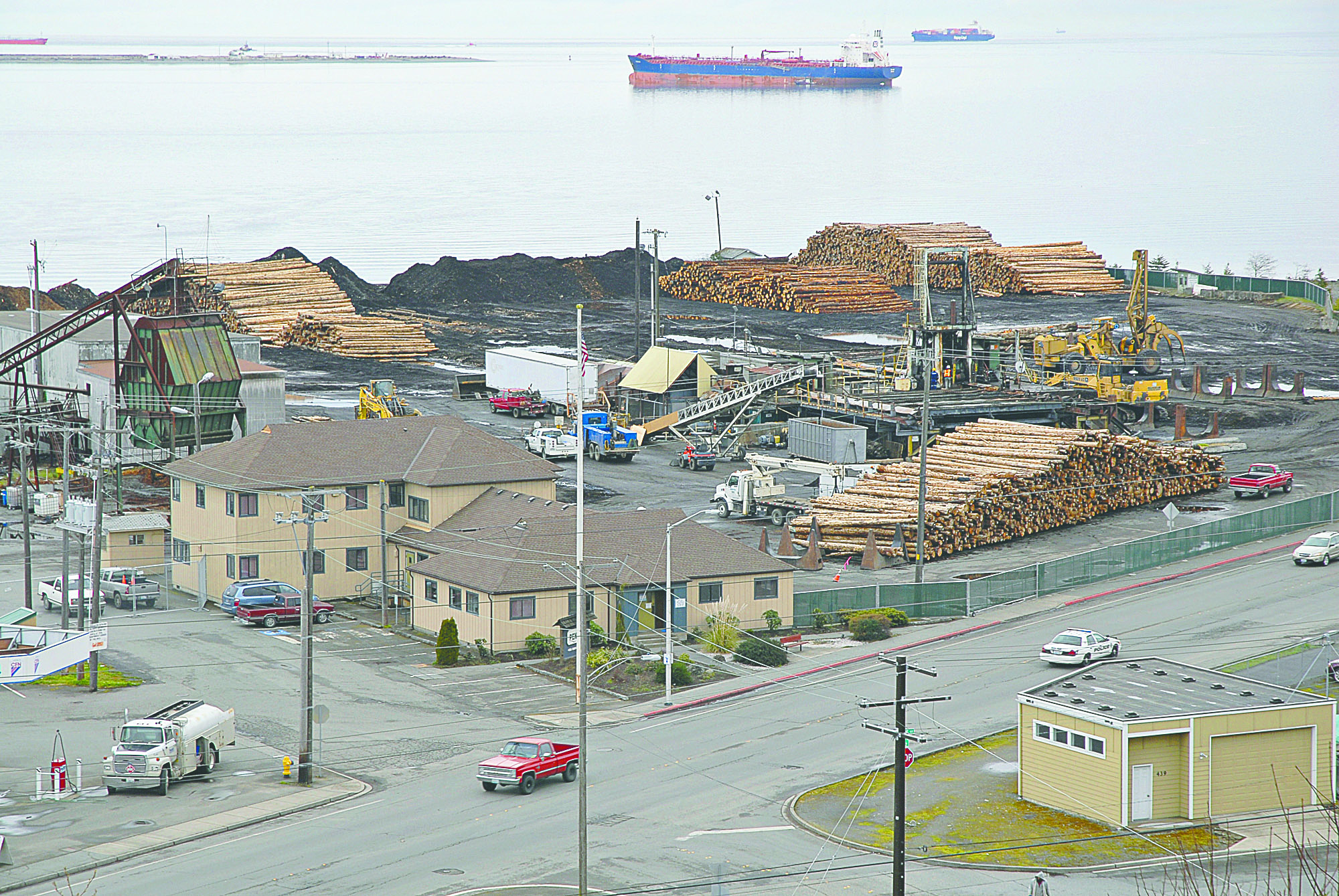 The former Peninsula Plywood manufacturing plant sits abandoned in Port Angeles except for logs awaiting export. Chris Tucker/Peninsula Daily News