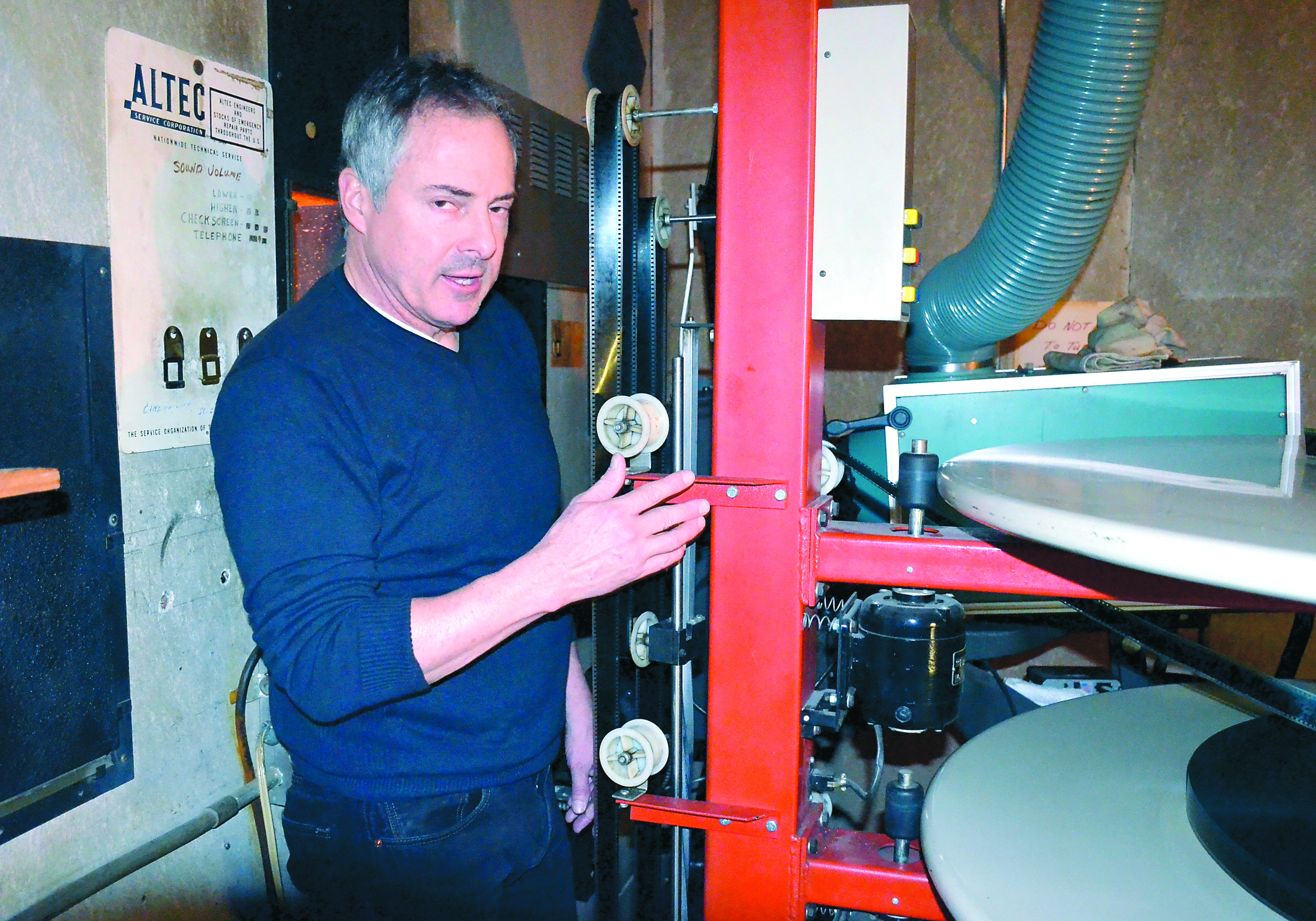Port Townsend's Uptown Theatre owner Rick Wiley loads film on the 35mm projector