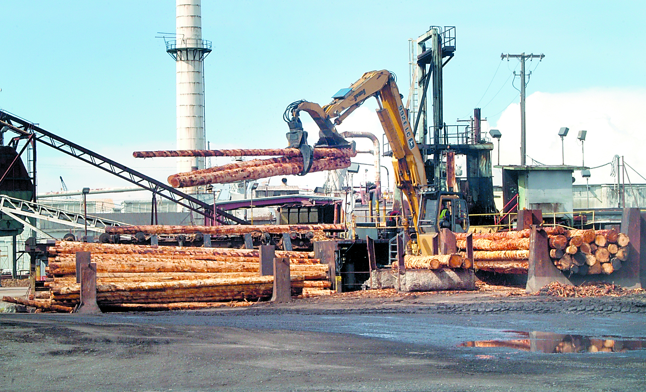 A loader moves logs from a debarker at the Peninsula Plywood mill in Port Angeles last week. The logs are being prepared for export. Keith Thorpe/Peninsula Daily News