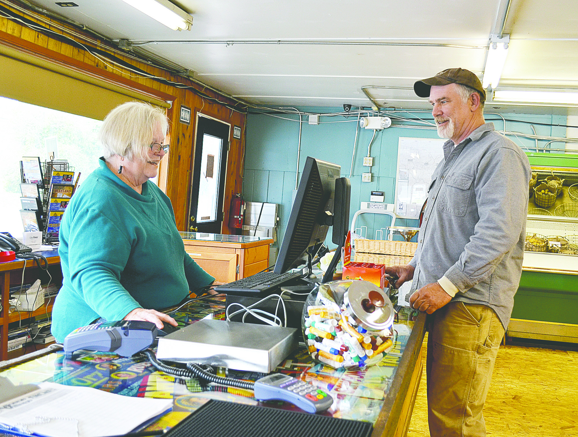 Cass Brotherton waits on John Helsper at the Quilcene Village Store on Thursday. The store is now open seven days a week