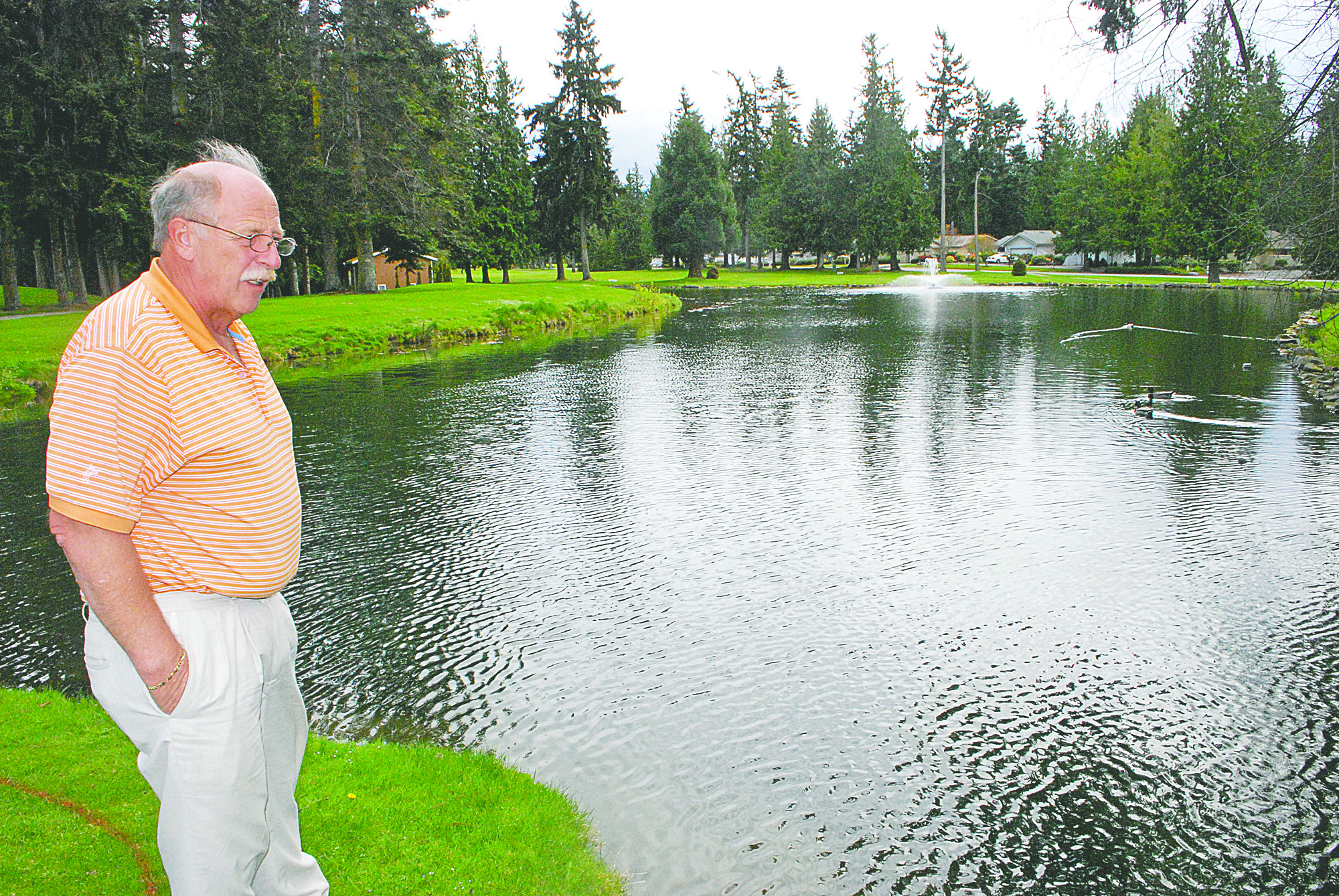 Bill Engle looks over  a pond with a fountain at SunLand Golf & Country Club. The private course is open to the public on the weekends. Jeff Chew/Peninsula Daily News