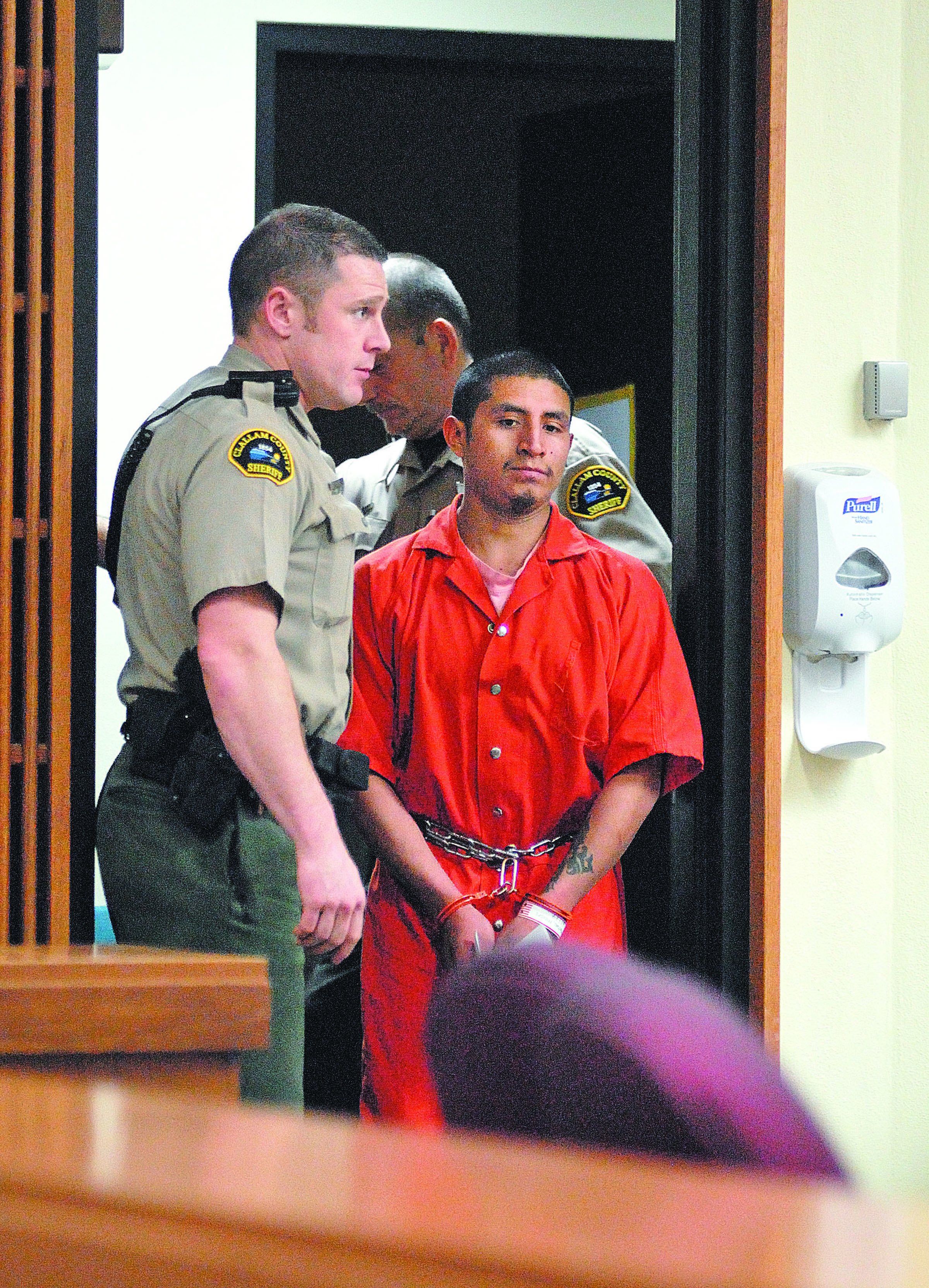 Moises Ramirez Matias enters Clallam County Superior Court accompanied by court security officer Eric Morris