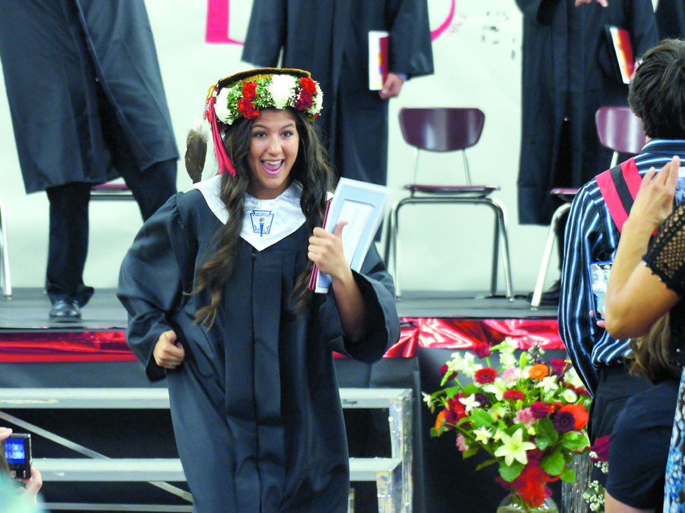 Rebecca Thompson grins after receiving her diploma from Neah Bay High School on Saturday. Brian Harmon/for Peninsula Daily News