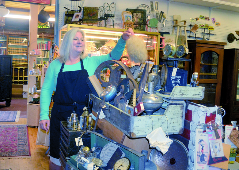 Port Townsend Antique Mall vendor Jan Dennler prepares a steampunk display in anticipation of this weekend's festival. Charlie Bermant/Peninsula Daily News