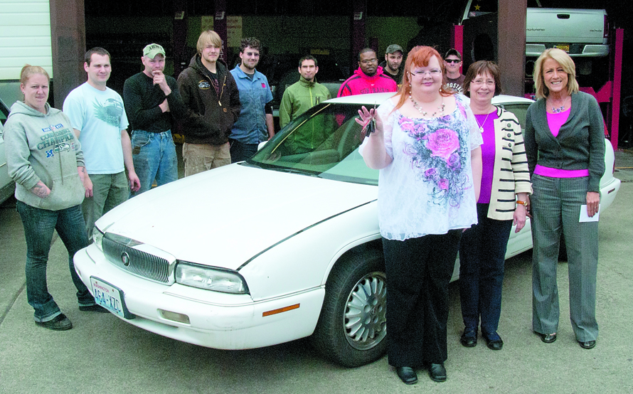 Second-year automotive students look on as Ruth Parks