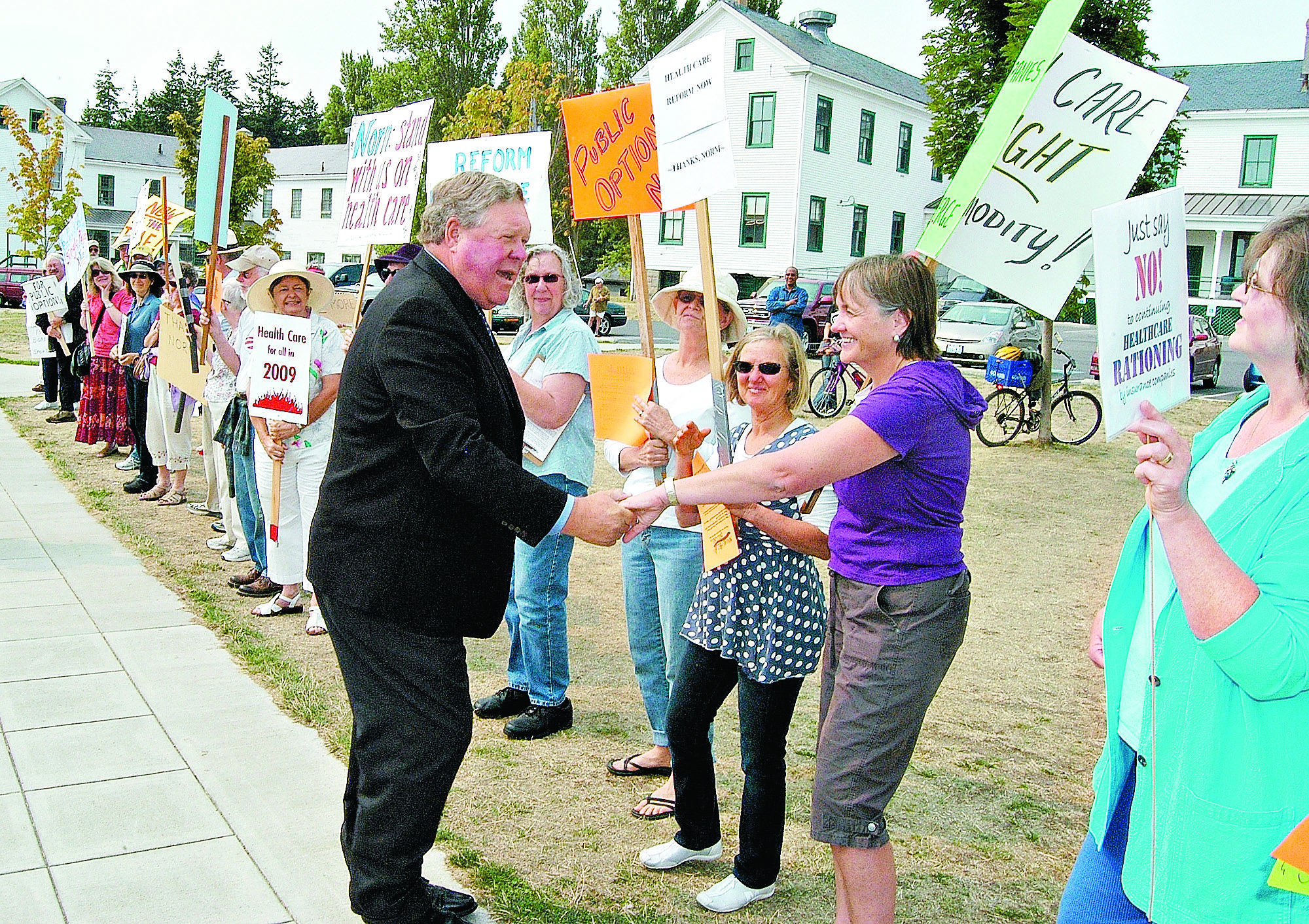 Rep. Norm Dicks is welcomed by a line of supporters of health care reform and related issues at Fort Worden State Park in Port Townsend in August 2009. The veteran congressman arrived to address the then-Port Townsend Chamber of Commerce.  -- Photo by Jeff Chew/Peninsula Daily News