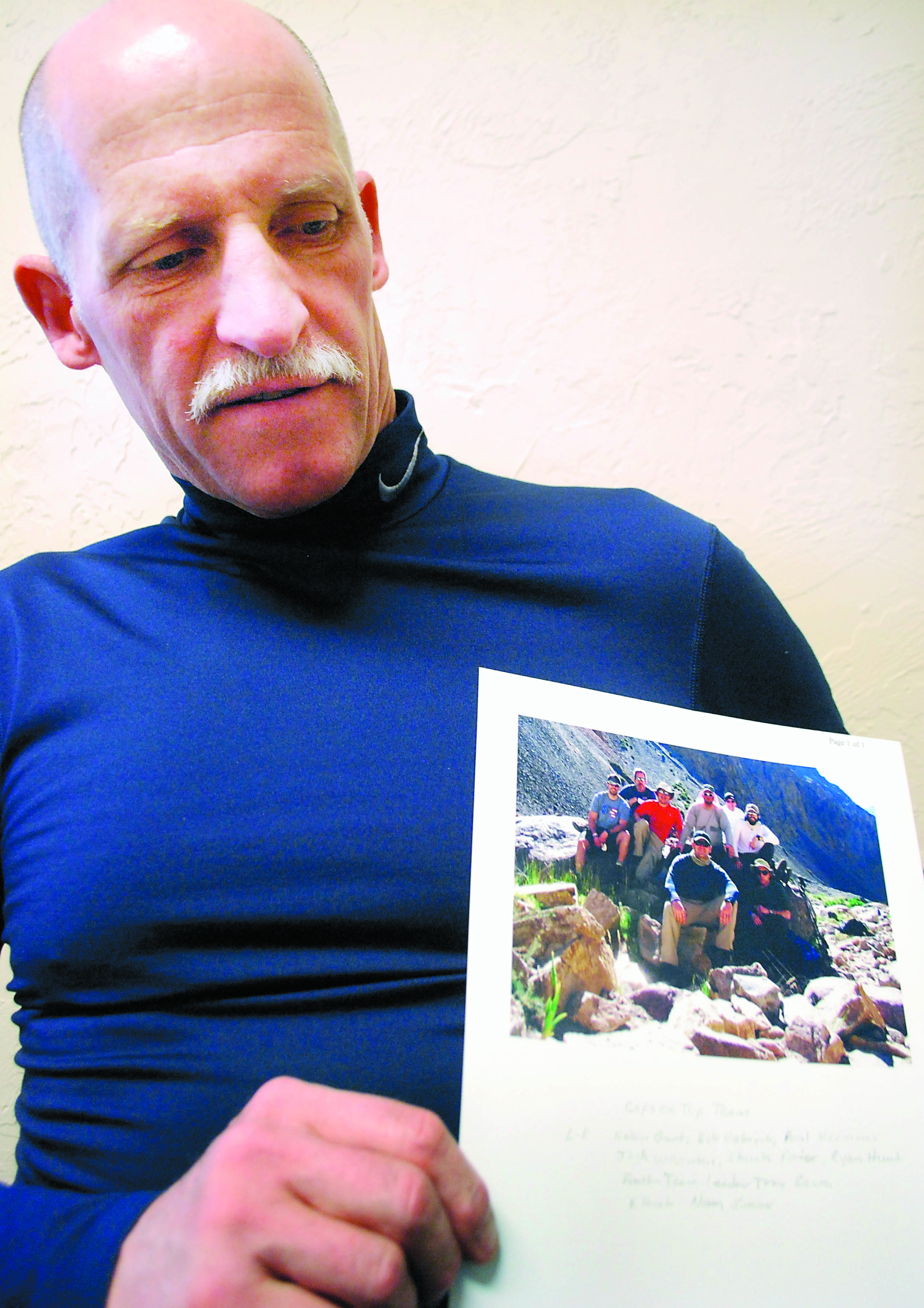 Sequim Police Officer Norman Simons shows a photo of the group of law officers who climbed Cerro Aconcagua in Argentina’s Andes Mountains