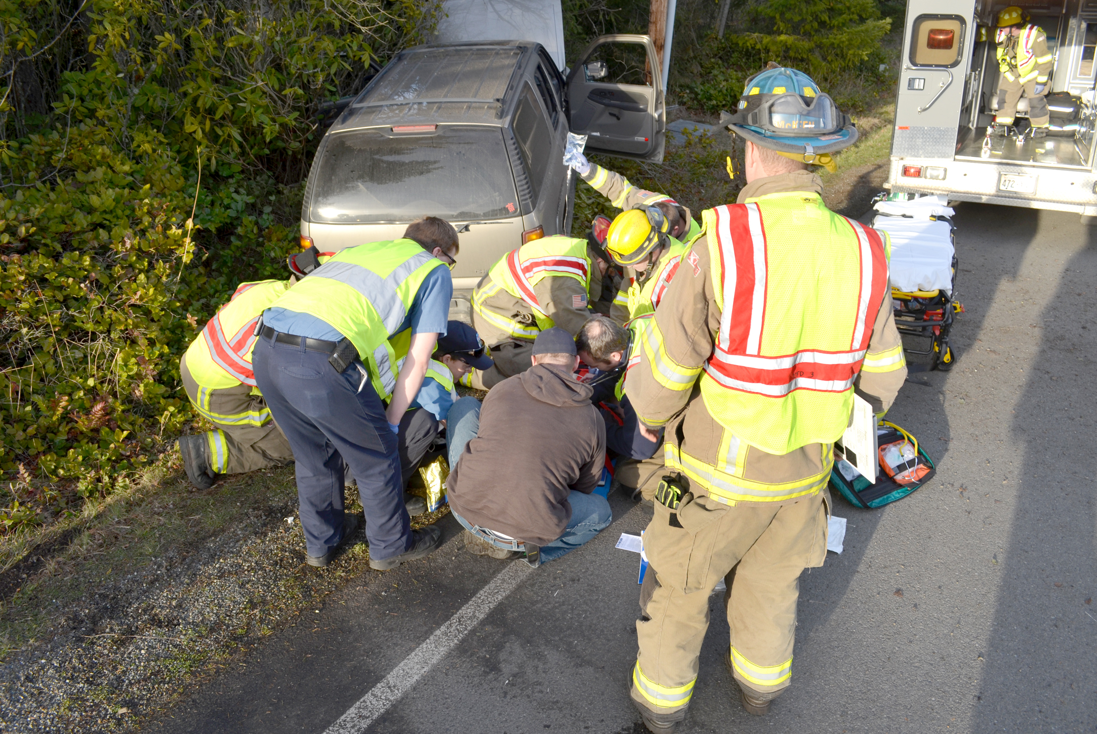 Clallam County Fire District No. 3 medics attend to a Sequim motorist who was suffering from an unknown medical condition in which she lost control of her vehicle Wednesday afternoon on U.S. Highway 101 at Chicken Coop Road. Patrick Young