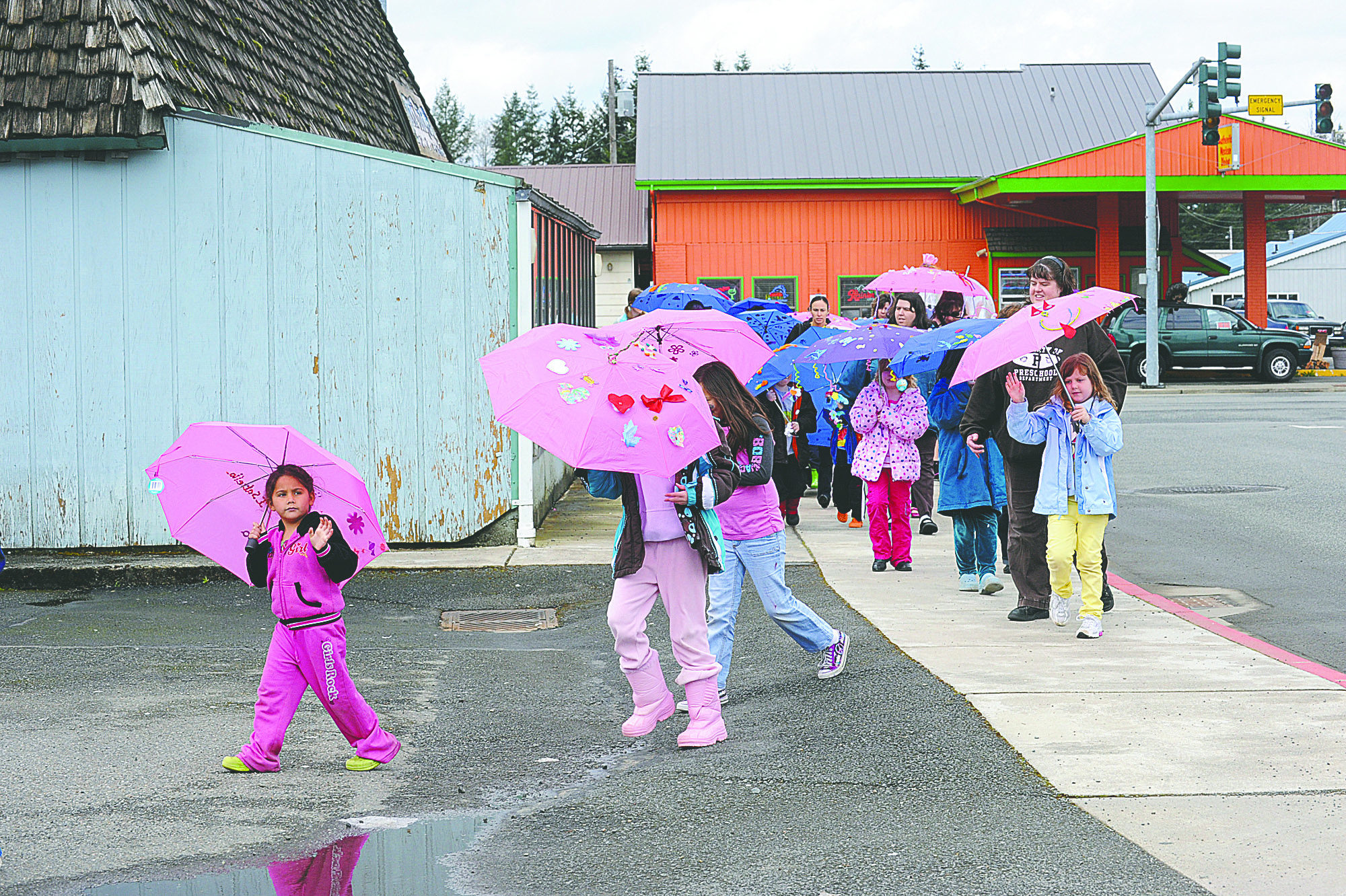 Children display their decorated umbrellas during the Umbrella Parade in 2011. This year's parade will begin at noon Saturday. Lonnie Archibald/for Peninsula Daily News