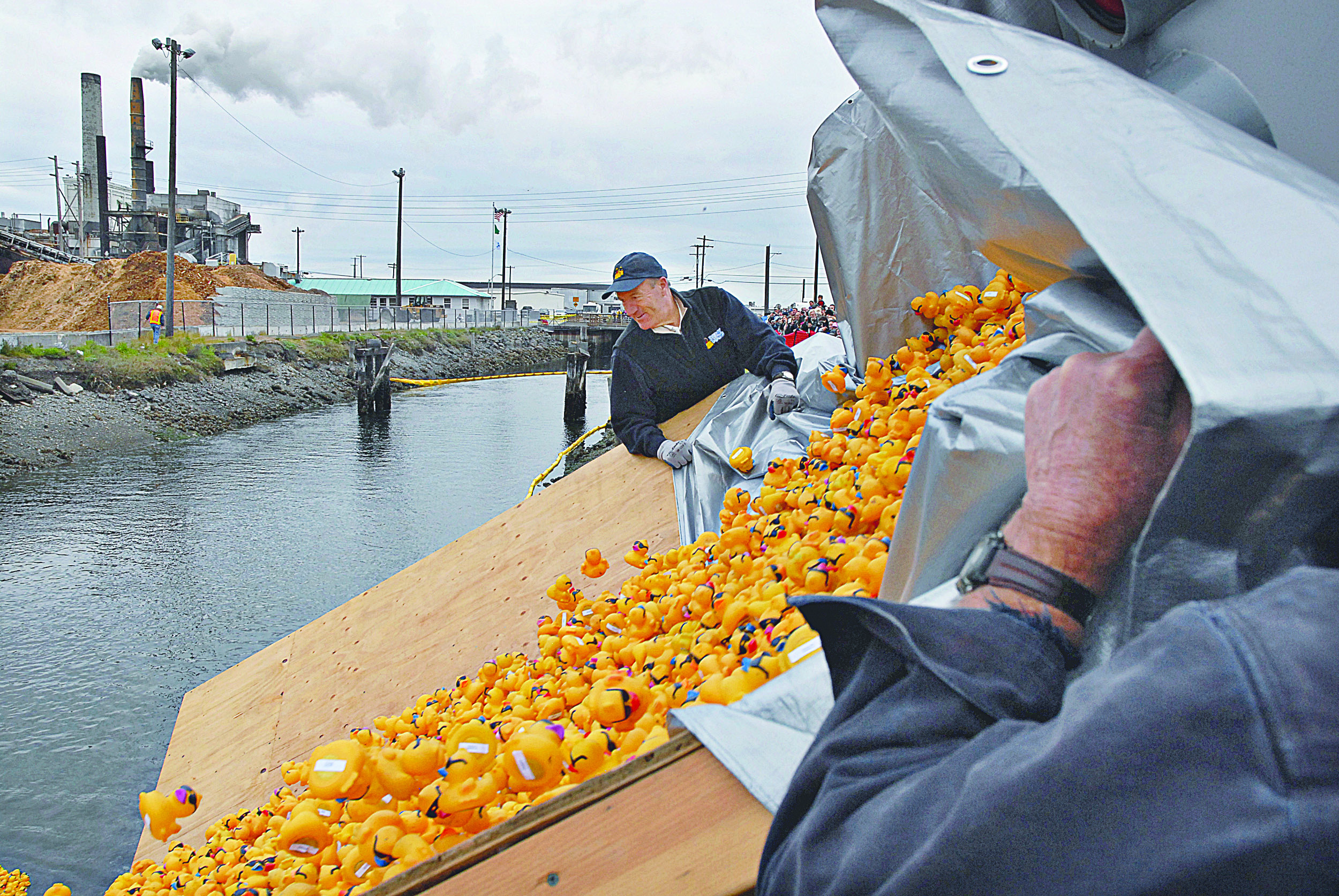 Rick Smitch watches as thousands of rubber ducks are dumped out of a truck
