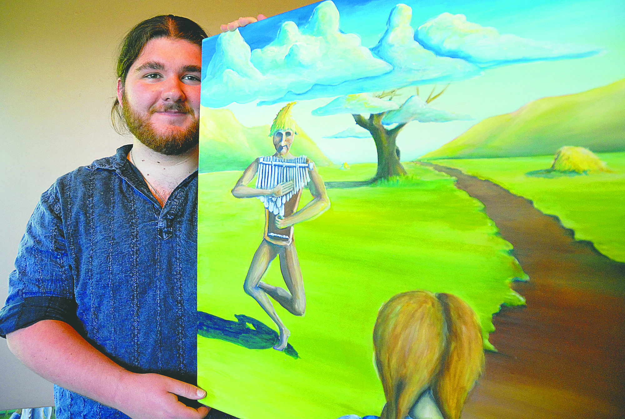 Patrick Carpenter displays one of his paintings inspired by “The Wizard of Oz” at the Port Angeles Fine Arts Center on Monday. Chris Tucker/Peninsula Daily News