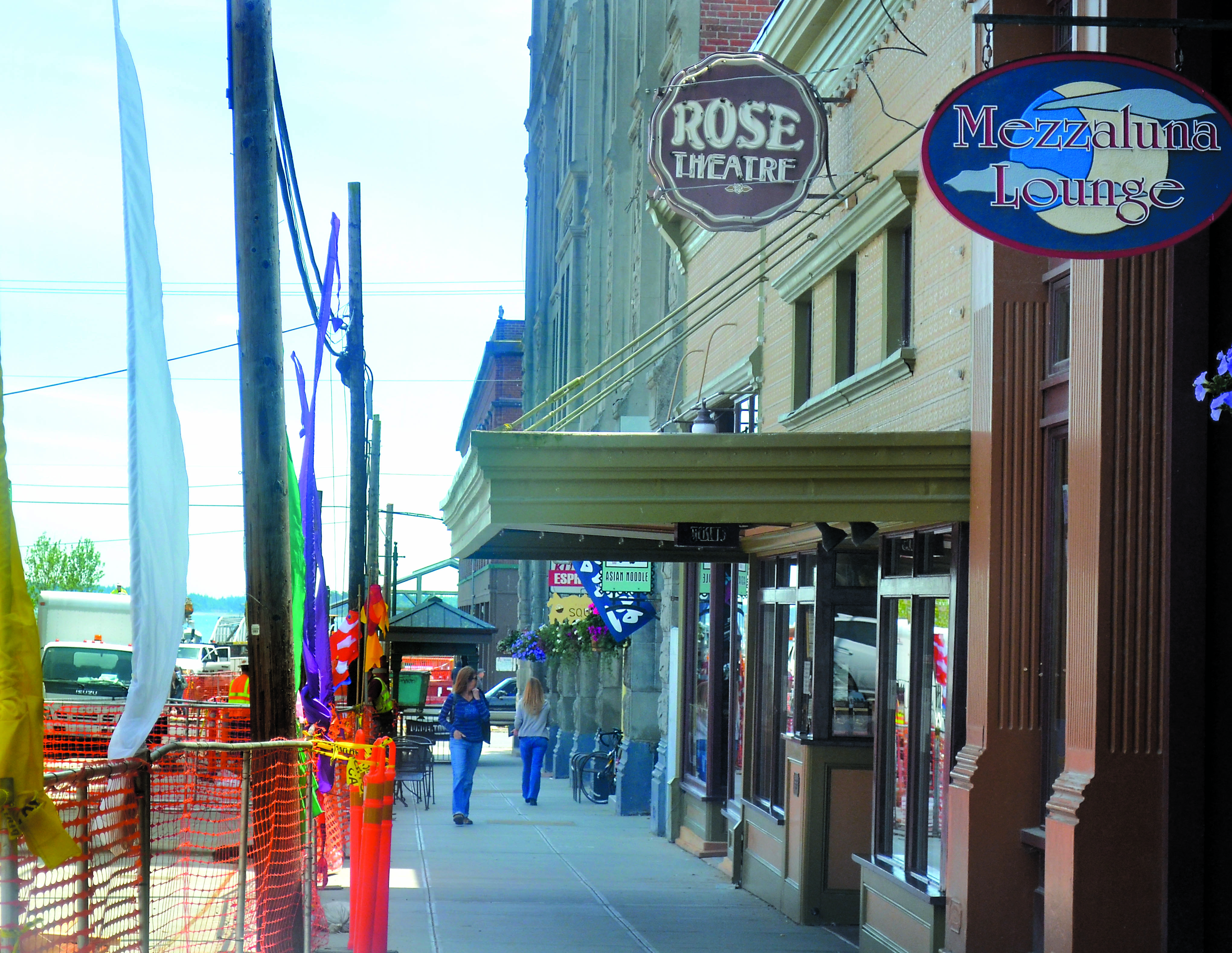 The utility poles on Taylor Street at left will stay in place until the end of July due to a mix-up in cable acquisition.  -- Photo by Charlie Bermant/Peninsula Daily News
