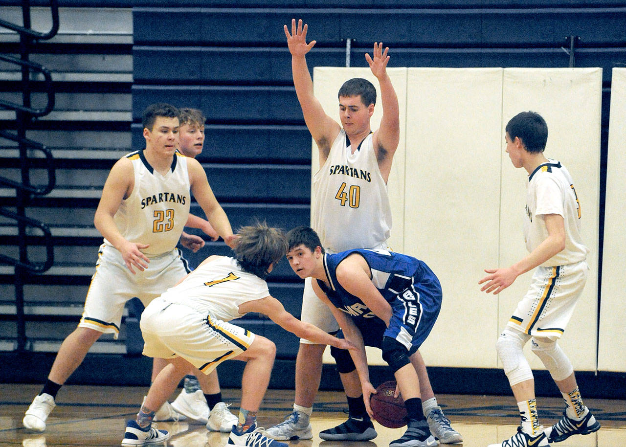 Lonnie Archibald/for Peninsula Daily News Spartans’ from left, Braton Armas, Seth Johnson, Scott Archibald and Jake Jacoby trap Elma’s Cobey Moore during Forks’ 59-40 Evergreen League win over Elma.