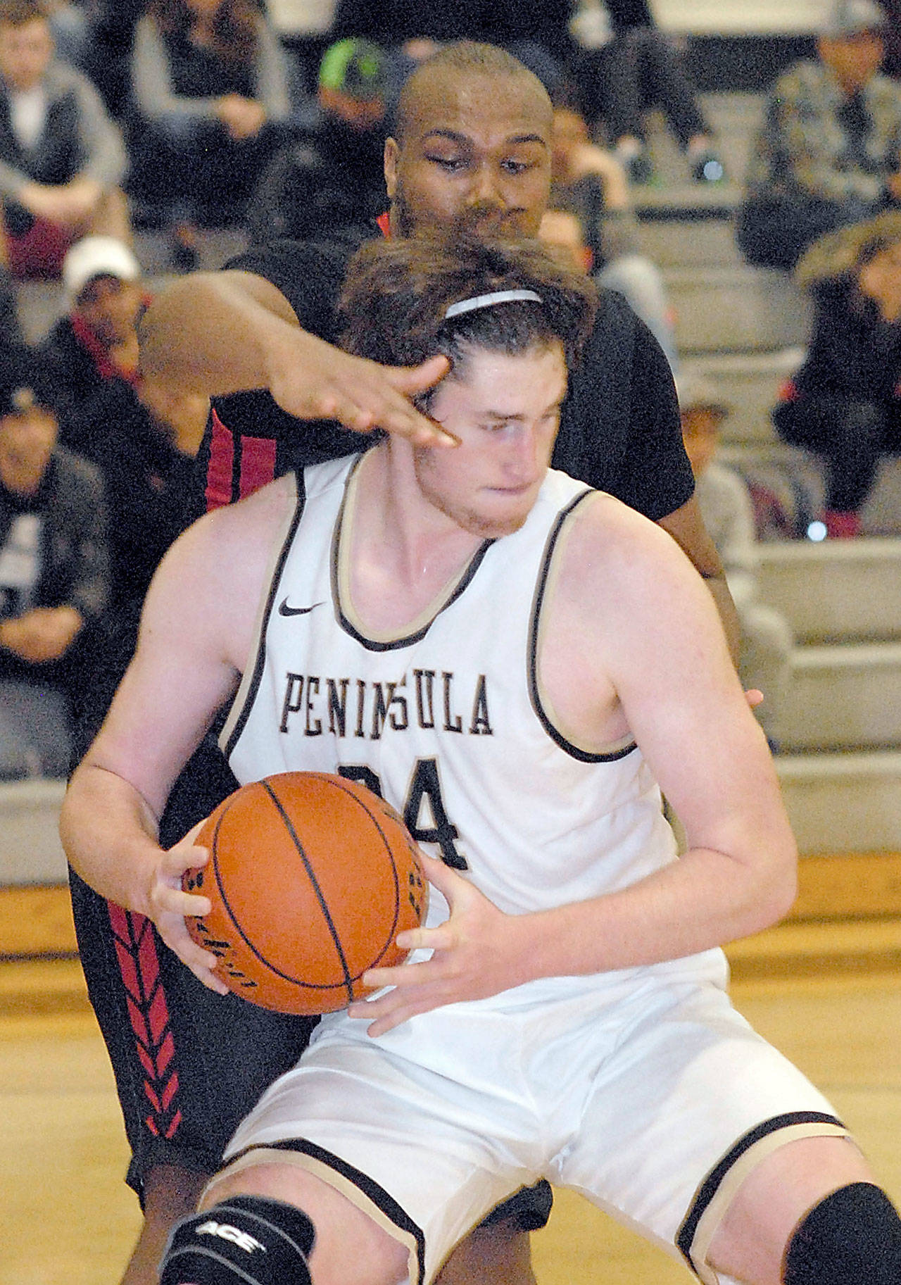 Keith Thorpe/Peninsula Daily News                                Peninsula’s Marky Adams tries to evade the defense of Mount Hood’s Terrell Walker during a November contest.