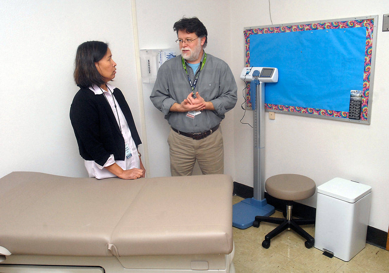 North Olympic Healthcare Network physician assistant Marilyn Stucker, left, and medical assistant Sean Clark talk in the new student health clinic at Port Angeles High School on Thursday. (Keith Thorpe/Peninsula Daily News)