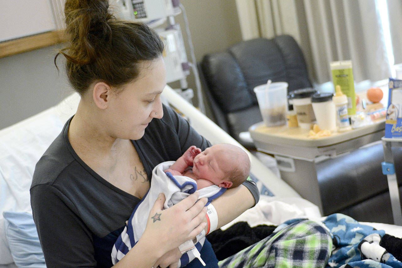 Shelby Thompson of Port Hadlock holds her new baby boy who was born Thursday. He was the first baby born in Jefferson County this year. (Jesse Major/Peninsula Daily News)