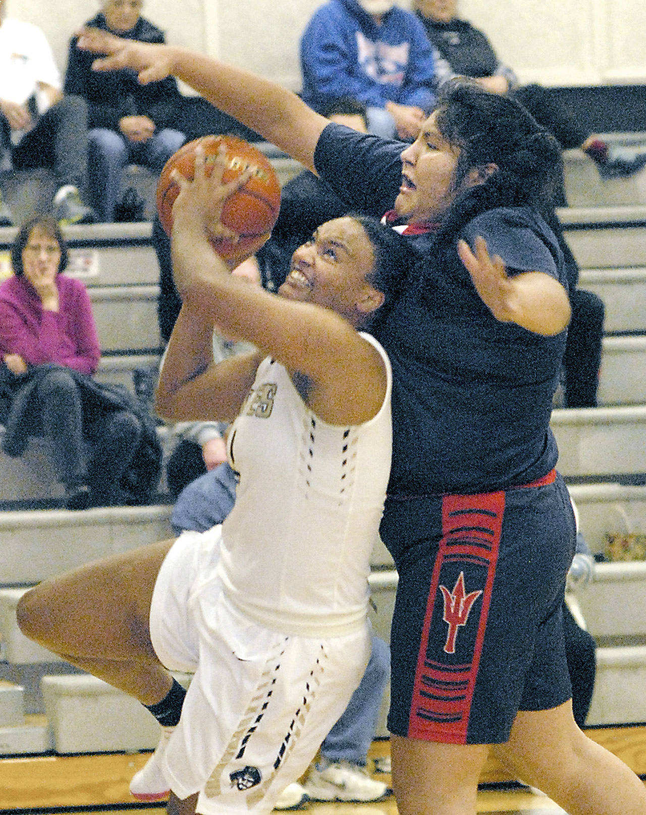 Keith Thorpe/Peninsula Daily News Peninsula’s Jamellia Clark, right, tries to evade the defense of Lower Columbia’s Nizhoni Wheeler, a Port Angeles High School alum, during the second quarter of Friday’s matchup in Port Angeles.