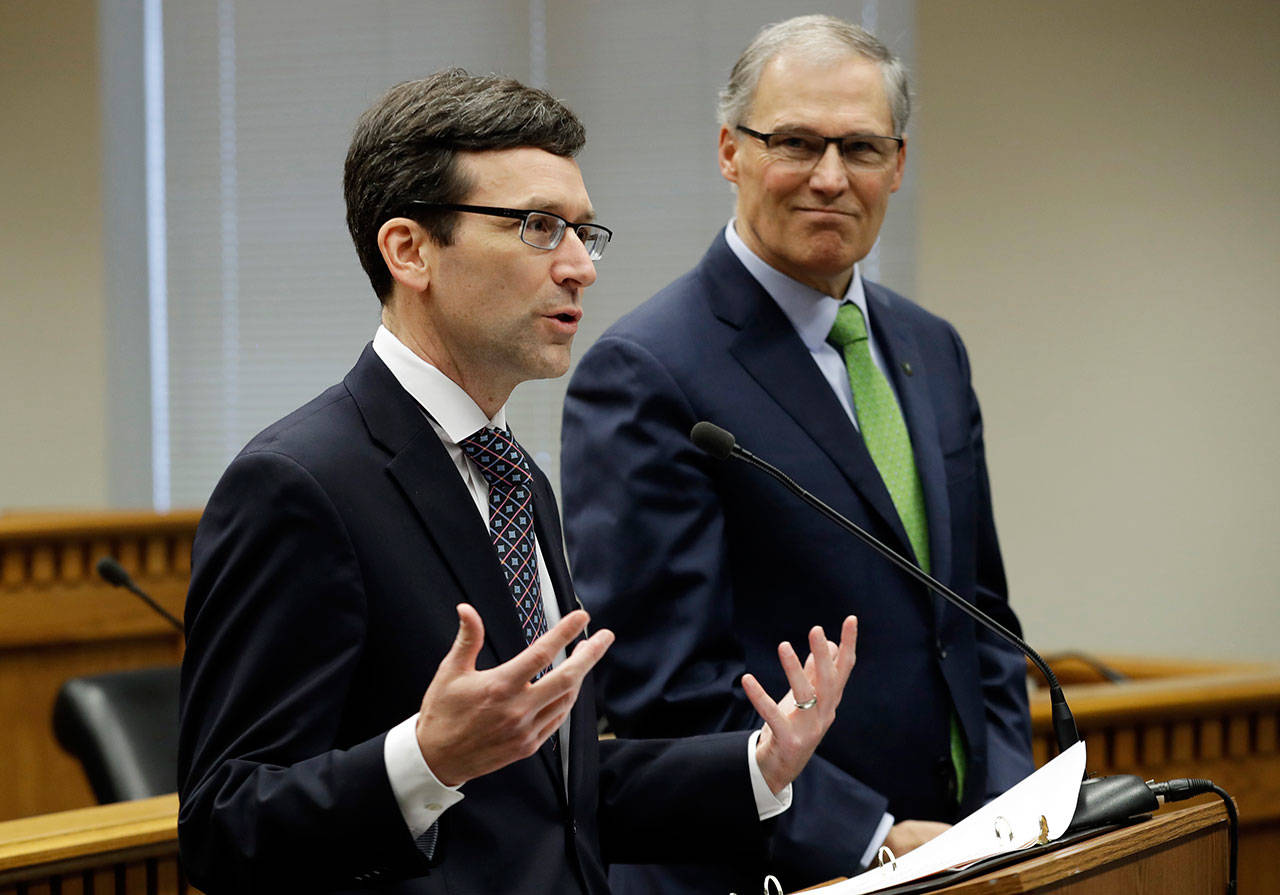 Washington Attorney General Bob Ferguson, left, talks to reporters as Washington Gov. Jay Inslee looks on during the Associated Press’ annual Legislative Preview last Thursday at the Capitol in Olympia. Inslee and Ferguson slammed the Trump administration’s move to roll back Obama-era leniency on legalized marijuana. (Ted S. Warren/The Associated Press)