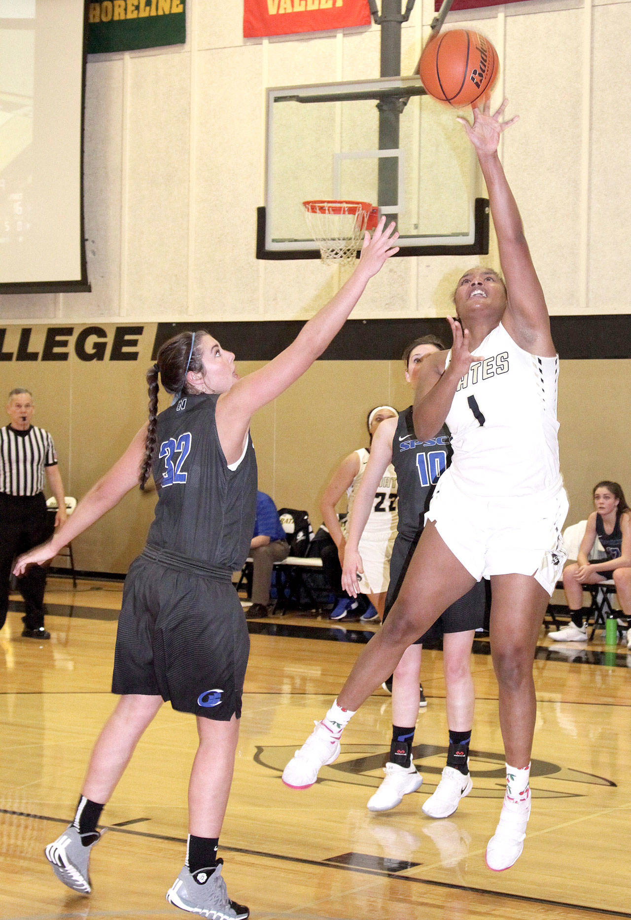Peninsulas Jamellia Clark goes up for a shot over the defense of Darion Brown of the South Puget Sound Clippers. (Dave Logan/for Peninsula Daily News)