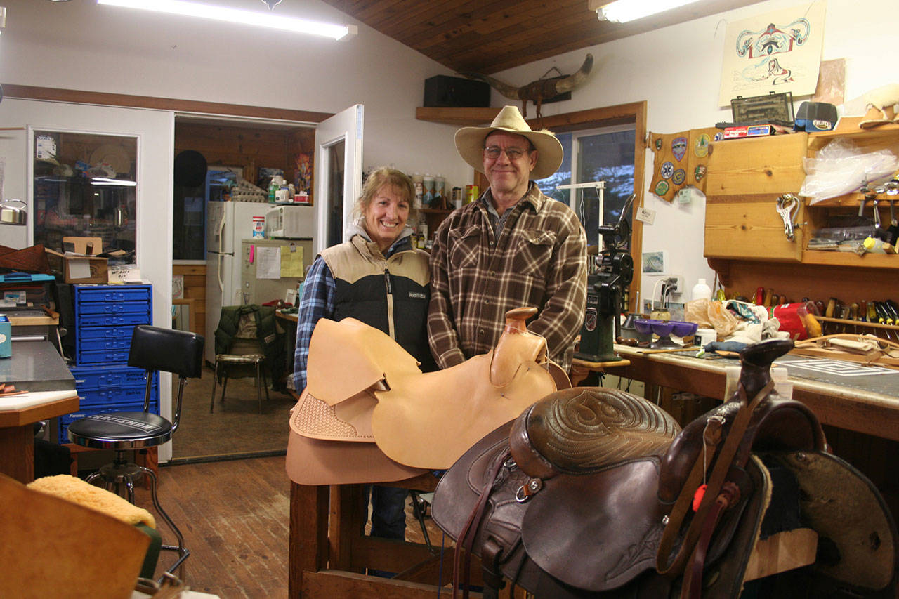 Guy Miller Saddlery and Leather Goods owners Kathy and Guy Miller make custom saddles, bridles, chinks and a host of other leather goods — along with repairing and refurbishing saddles — out of their Port Angeles home. (Karen Griffiths/for Peninsula Daily News)
