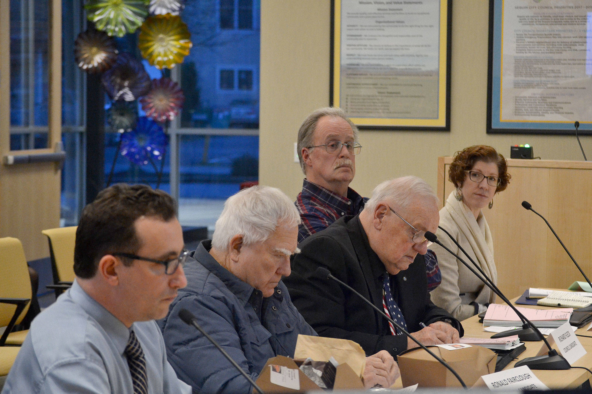 Candidates, sitting from left, David Eaton, Ron Fairclough, Richard Fleck, Bernard “Buddy” Fleck, and Jennifer States field questions during the application process Monday for the vacant Sequim City Council position. (Matthew Nash/Olympic Peninsula News Group)