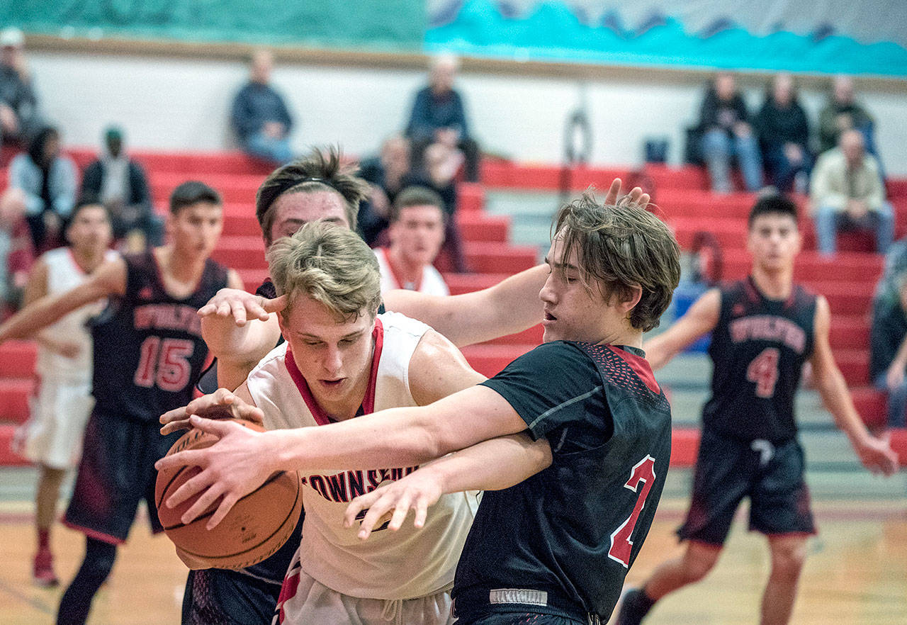Steve Mullensky/for Peninsula Daily News                                Port Townsend’s Kaiden Parcher, left, duels with Coupeville’s Ethan Spark for control of the ball during the Redhawks 55-27 win Tuesday.