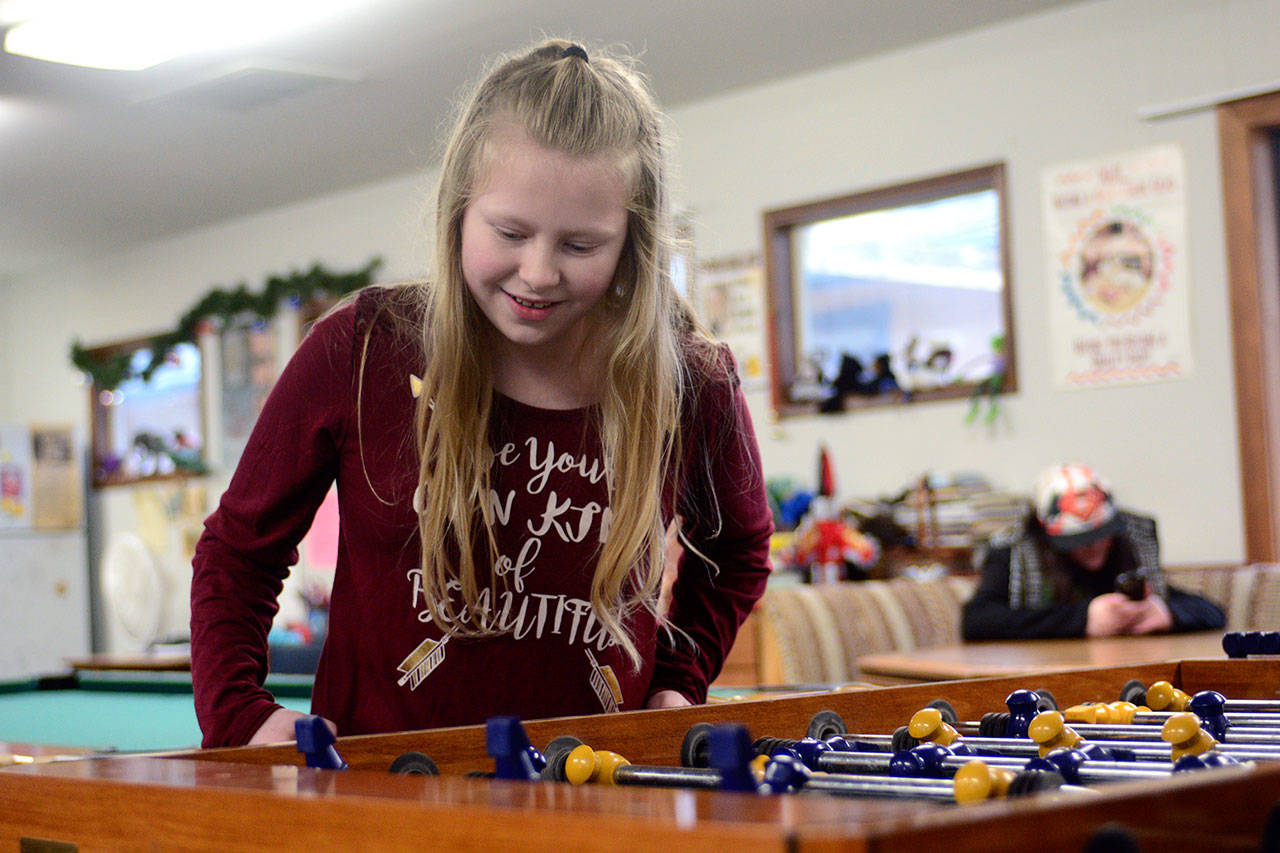 Taylor Richards, a sixth-grade student in Chimacum, plays foosball at the Jefferson Teen Center in Chimacum on Friday. (Jesse Major/Peninsula Daily News)