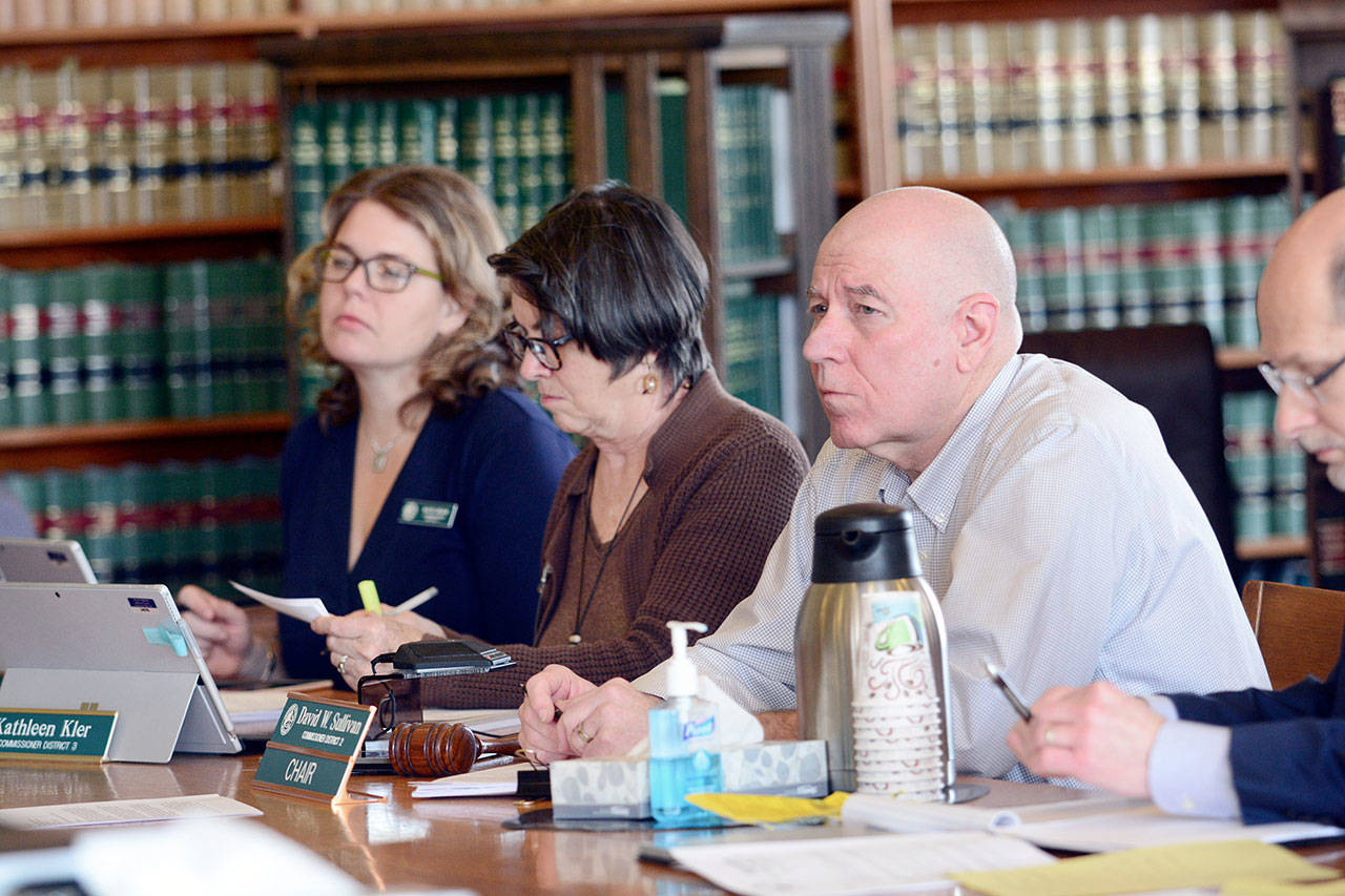 From left, Jefferson County commissioners Kate Dean, Kathleen Kler and David Sullivan listen to public comment Tuesday. (Jesse Major/Peninsula Daily News)